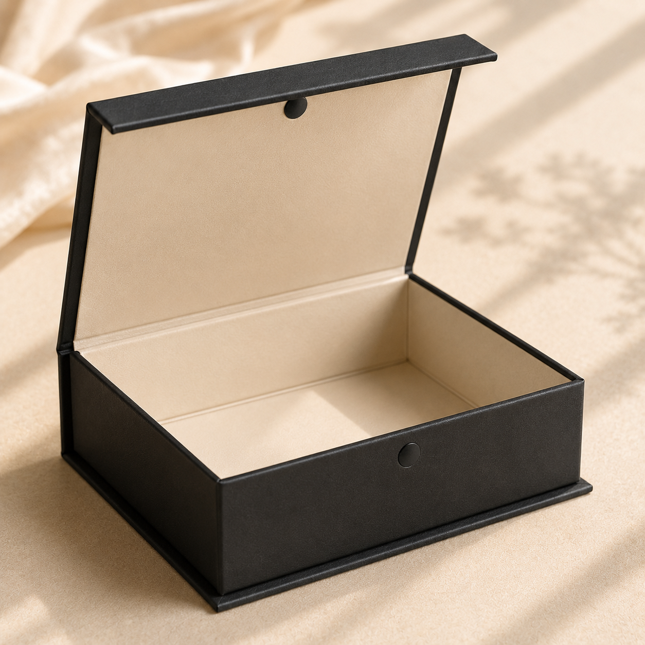 Foil-stamped rigid magnetic closure influencer box in near-black with champagne gold accent